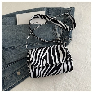 Detail of zebra pattern shoulder bag with a rectangular flap and wide strap design