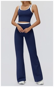 Detail of high-waist flared yoga pants and racerback top with white contrast piping