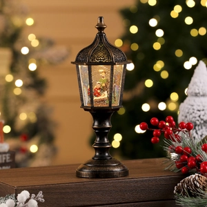 Macro detail of bronze Christmas lantern with Nativity scene and sparkling silver glitter