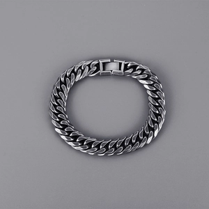 Detail view of dark grey stainless steel Cuban chain bracelet with a secure folding clasp