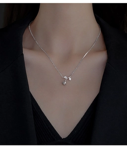 Close-up of S925 sterling silver rose pendant with zircon leaves on model neck