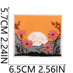 Embroidered sun patch with pink flowers and mountains showing size measurements