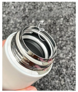 Detail shot of the smooth rounded rim and polished interior of white stainless steel flask
