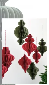 Detail of red and olive green honeycomb paper ornaments in vintage onion shape for Christmas