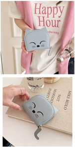 Detail of light blue cat-shaped coin purse with embroidery and tail zipper pull