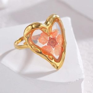 Golden titanium steel ring with heart-shaped resin-encased orange dried flower