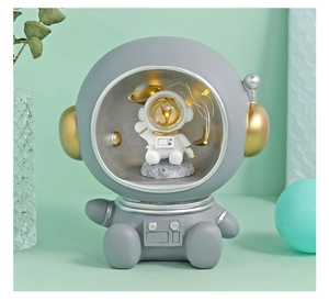 Detail of an astronaut night light with LED fairy lights inside the golden visor