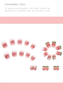 Detail of gradient pink press-on nails with lemon and watermelon fruit patterns
