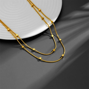 Double-layered gold titanium steel necklace with square cube charms on flat snake chains
