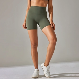 Detailed view of high-waist olive green yoga shorts with seamless compression fabric