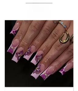 Detail of pink and purple press-on nails with 3D floral relief and pearl accents