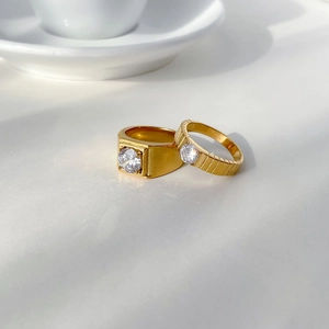 Luxurious gear design couple rings with round crystal stones in polished gold finish
