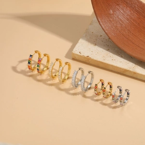 Close-up of 14K gold plated hoop earrings featuring rainbow and clear cubic zirconia