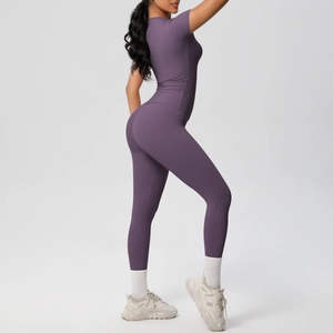 Detail view of the seamless high-waist yoga pants and fitted dark purple sports top