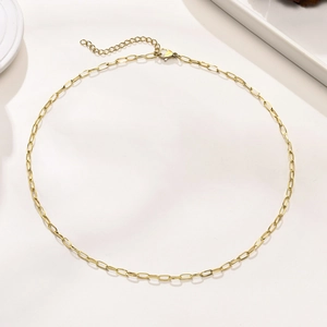 Close-up of golden paperclip chain necklace with lobster clasp and adjustable link