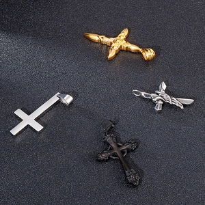 Detail von vier verschiedenen Kreuzanhängern aus Edelstahl in Gold, Silber und Schwarz