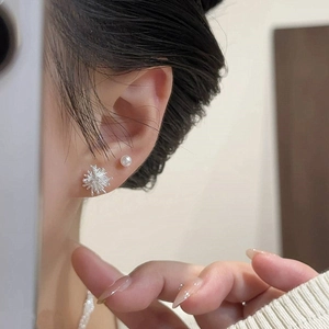 Minimalist silver stud earrings set with pearl and starburst firework design for women