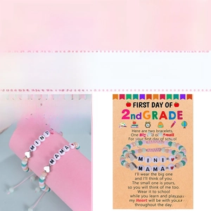 Close-up of Mama & Mini macaron beaded bracelets set on themed back to school card