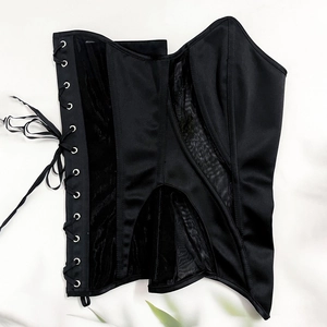 Detail of vintage black satin corset top featuring mesh panels and side lace-up eyelets