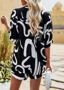Rear view of women's black and white printed vacation set with loose shirt and shorts