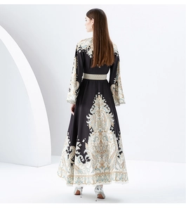 Detailed back view of printed maxi dress with paisley motifs and lace flare sleeves