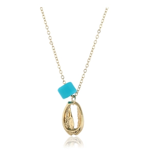 Close-up of golden shell pendant with turquoise bead on a minimalist chain necklace