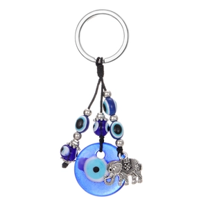 Vintage evil eye keychain with blue beads and silver metal elephant charm on white background