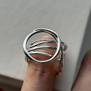 Macro shot of minimalist multi-layer S925 sterling silver ring with circular loop design