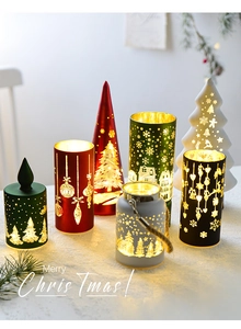 Detailed view of hollowed-out Christmas tree candle holders with warm LED glowing effect