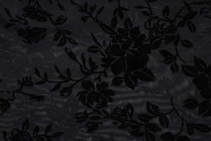 Gros plan sur tissu en maille transparente noire avec motifs floraux floqués
