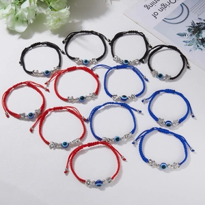 Fashionable braided red string evil eye bracelets set with various silver charms