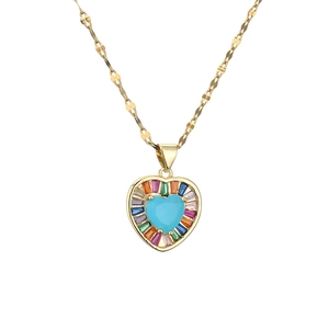 Elegant gold necklace featuring a turquoise heart pendant with colorful crystals on white background