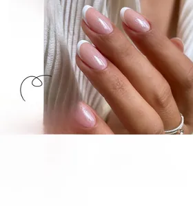 Detailed view of French tip press-on nails with nude pink base and subtle silver glitter