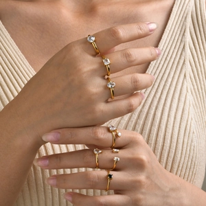 Women's 18K gold plated stainless steel rings set with various zircon shapes on a model