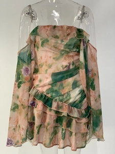 Detailed ruffled layers of a floral chiffon off-shoulder dress on a clear mannequin
