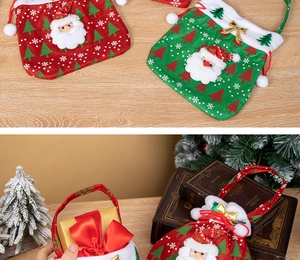 Detail of Christmas Santa drawstring gift bags with 3D decor on wooden background