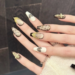 Handmade black and gold coffin nails with lattice heart patterns and 3D cross charms