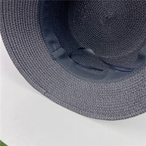 Deep blue straw sun hat featuring adjustable inner sweatband and spiral woven texture