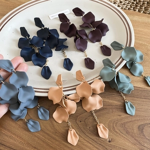 Detail of matte acrylic flower petal tassel earrings in multiple colors and layers