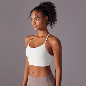 Detailed back view of white sports bra with criss-cross thin straps and wide hem support