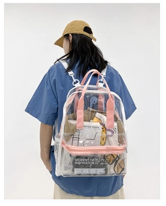 Pink trim clear PVC backpack shown from behind on a model with magazines and clothes inside