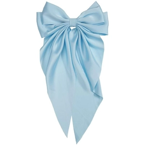 Detail of light blue satin bow hair clip with long ribbons and silky glossy finish
