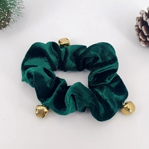 Detail of dark green velvet Christmas scrunchie with three golden bells and pine cones