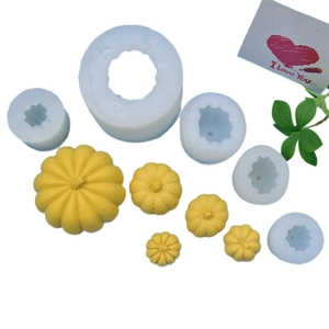 Five sizes of pumpkin silicone molds with yellow candle models for Halloween DIY crafts