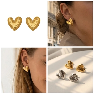 Detail showing heart earrings with hammered texture finish in gold and silver colors