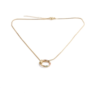 Detail of gold snake chain necklace with colorful gemstone circular pendant and screw thread