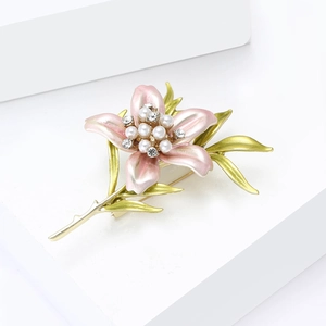 Detail of pink lily brooch featuring enamel petals, white pearls and gold leaves