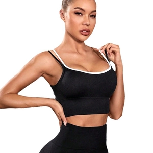 Women's black yoga set with high-elastic sports bra and leggings featuring white piping