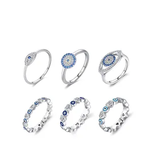 S925 sterling silver evil eye rings with blue stones in various styles on white background
