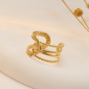 Gold plated stainless steel multi-layer twisted ring with beads on white background